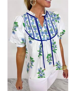 Bloemenprintdesign voor een fashionable uitstraling  
Strikdetail voegt een unieke touch toe  
Korte mouwen voor comfort  
Materiaal: 100% polyester