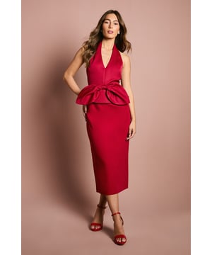 Striking halter neck design with elegant V neckline for a sophisticated dcolletage
        Structured satin fabric creates a luxurious sheen and maintains the dress's architectural form
        Statement bow detail at the waist creates a dramatic peplum silhouette
        Figure-flattering column cut with midi length and back vent for ease of movement
        Open back design adds an alluring touch to this occasion-ready ensemble
    
    Make a captivating entrance at your next special event in this architectural Coast midi dress. The halter neck design frames the shoulders beautifully whilst the deep V neckline offers a refined touch of allure. The standout feature is undoubtedly the structured bow detail that creates a striking peplum effect, cinching the waist and enhancing your silhouette. The sleek column cut skims the body elegantly, whilst the back vent ensures you can move with grace throughout the day. Style with matching heels as shown for a coordinated look, or contrast with metallic accessories for added dimension. Perfect for weddings, race days or formal gatherings, this dress commands attention whilst maintaining an air of sophistication. Complete your ensemble with delicate jewellery and a structured clutch for an impeccably polished appearance.