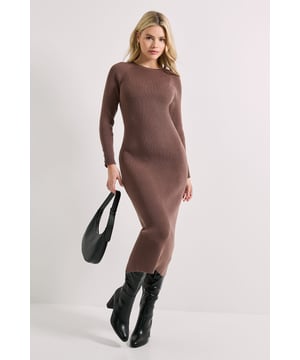 Elegant knitted midi dress with a flattering slim silhouette
        Sophisticated crew neckline for versatile styling options
        Decorative button detailing on cuffs adds refined interest
        Long sleeves provide warmth and coverage for transitional seasons
        Ribbed texture creates a figure-enhancing fit that maintains its shape
    
    This Dorothy Perkins knitted midi dress combines comfort with understated elegance, perfect for the woman who appreciates contemporary style with a modest approach. The slim-fitting silhouette gently contours your figure while the midi length offers sophisticated coverage that works beautifully for daytime occasions. Style with knee-high boots and a structured handbag as shown for casual brunches with friends, or dress it up with block heels and statement earrings for family gatherings. The button cuff detail adds a thoughtful finishing touch to this versatile piece. Layer with a longline cardigan and trainers for weekend errands, or add a tailored coat and ankle boots for a polished look that transitions effortlessly from day to evening. This knitted essential will quickly become your go-to for those "nothing to wear" moments throughout the season.