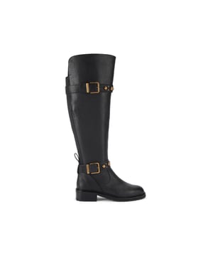 This Kurt Geiger Dome Stud Riding Boot is crafted from a black pebble grain leather with antiqued brass studs across both the buckled straps.