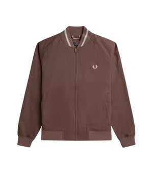 The Fred Perry Carrington Brick Tennis Bomber Jacket combines classic style with modern comfort. Crafted from 100% cotton, this jacket offers breathability and softness ideal for everyday wear or light outdoor activities. Its distinctive brick color and corduroy detailing add a refined edge to the iconic tennis bomber silhouette. Designed with durability and style in mind, it's a versatile piece perfect for layering in cooler weather while making a confident fashion statement. Elevate your wardrobe with this expertly tailored jacket that embodies timeless British craftsmanship