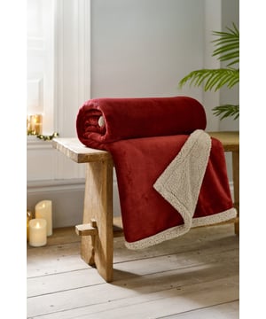 The Hazelwood Throw in Wine brings a touch of warmth and luxury to your home. This 130x170cm flannel and sherpa blanket offers ultra-soft comfort and a rich, bold colour, making it a cosy statement piece for any room.