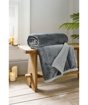 Chic and timeless, the Hazelwood Throw in Silver blends beautifully into any living space. Crafted with a smooth flannel front and sherpa reverse, this 130x170cm blanket is ideal for cosy evenings or as a stylish layer over furniture.