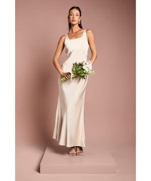 Elegant square neckline with wide shoulder straps for a sophisticated silhouette
        Luxurious satin fabric with crepe detailing creates a beautiful contrast of textures
        Striking bow detail at the back adds a romantic flourish
        Figure-flattering fitted bodice that flows into a graceful floor-length skirt
        Sleek column silhouette with a subtle flare towards the hem for ease of movement
    
    This stunning bridesmaids dress from Coast combines timeless elegance with contemporary design elements. The square neckline frames the dcolletage beautifully, whilst the fitted bodice creates a flattering silhouette that complements various body types. The showstopping bow detail at the back transforms this dress from simple to spectacular, adding a touch of romance that photographs beautifully during wedding celebrations. Style with delicate drop earrings and a sleek updo to showcase the elegant neckline, or opt for loose waves for a softer look. Complete your bridal party ensemble with strappy heeled sandals and a small posy that complements the bridal bouquet. This versatile dress works wonderfully in matching colour palettes for a cohesive bridal party look, allowing the bride to shine whilst ensuring her supporting attendants look equally refined.