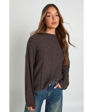 High neck design for extra warmth and contemporary style
        Distinctive vertical seam detailing creates visual interest and texture
        Relaxed silhouette with dropped shoulders for effortless comfort
        Wide sleeves with clean-finished cuffs for a modern look
        Versatile cropped length perfect for pairing with high-waisted bottoms
    
    This Seam Detail High Neck Knitted Jumper from Boohoo combines comfort with contemporary design elements. The standout vertical seams create a structured aesthetic while maintaining a relaxed fit that works brilliantly for casual occasions. Style it as shown with wide-leg jeans for a balanced silhouette that's perfect for weekend brunches or casual family gatherings. The high neck offers both warmth and style during cooler months, while the cropped length makes it ideal for showcasing high-waisted trousers or skirts. For a complete daytime look, add a roomy tote bag and comfortable flat boots. This jumper transitions seamlessly from coffee dates to shopping trips, offering that coveted blend of comfort and style that's essential for your everyday wardrobe. Layer under an oversized coat when temperatures drop for additional warmth without sacrificing style.
