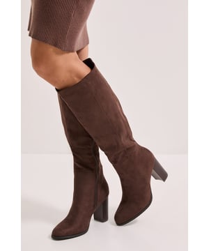Sleek long leg design with a sophisticated silhouette
        Sturdy block heel measuring between 7-9cm for comfortable height
        Side zip fastening for easy wear
        Soft-touch PU upper with a suede-like finish
        Rounded toe shape for all-day comfort
    
    The Kit High Heel Long Leg Boot from Dorothy Perkins offers the perfect blend of style and practicality for your daywear wardrobe. These versatile boots feature a substantial block heel that provides stability whilst adding a touch of elegance to your ensemble. Style them with a ribbed midi dress as shown for a chic brunch look, or pair with skinny jeans and an oversized jumper for weekend coffee dates. The knee-high design works beautifully with midi skirts for family gatherings, whilst the neutral tone ensures they'll complement numerous outfits in your collection. These boots transition effortlessly from shopping trips to casual dinner dates, making them an essential addition to your autumn-winter wardrobe. The comfortable rounded toe and manageable heel height mean you can confidently wear them throughout the day without compromising on style.