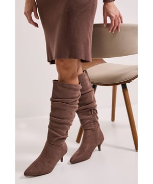 Wide fit design for enhanced comfort and roomier fit around the calf
        Elegant ruched detailing creates a relaxed, slouchy texture throughout the boot shaft
        Practical side zip fastening for easy wear
        Comfortable kitten heel measuring between 2.5-4.5cm in height
        Soft faux suede finish with a pointed toe silhouette
    
    These Dorothy Perkins Khloe knee-high boots combine practicality with on-trend style. The ruched detailing adds texture and interest whilst the modest kitten heel offers all-day wearability without sacrificing elegance. Perfect for casual daywear, these boots pair beautifully with knitted dresses as shown, or style with skinny jeans and an oversized jumper for weekend brunches with friends. The wide fit design ensures comfort for all-day wear, whilst the versatile knee-high length works wonderfully for autumn through winter. Ideal for family gatherings or coffee dates, these boots offer the perfect balance of comfort and style for the woman who wants to look fashionable without compromising on practicality. The pointed toe adds a touch of sophistication to this everyday essential.