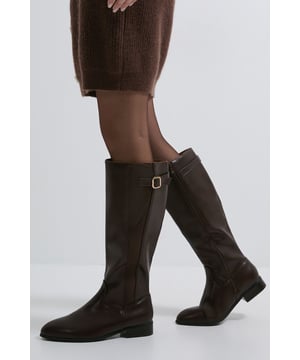 Knee-high riding boot design with elastic panel for comfortable fit
        Decorative buckle detail on the outer shaft adds a refined touch
        Flat heel measuring under 2cm for all-day wearability
        Smooth faux leather finish with a classic silhouette
        Versatile round toe shape perfect for everyday styling
    
    The Kamille Knee High Riding Boots from Dorothy Perkins offer timeless equestrian-inspired style with practical everyday comfort. The elastic panel ensures these boots fit snugly against the calf while allowing ease of movement throughout your day. Style them with slim-fit jeans tucked in and an oversized jumper for casual weekend brunches with friends. Alternatively, pair with a midi skirt and tights for a sophisticated look that works beautifully for family gatherings or baby showers. The flat heel provides stability and comfort for extended wear, making these boots an excellent choice for city exploring or countryside walks. Their classic design means they'll complement virtually any casual outfit in your wardrobe, offering versatility season after season. The subtle buckle detail adds just enough interest without overwhelming your look, making these boots a reliable staple for the fashion-conscious woman who values both style and comfort.