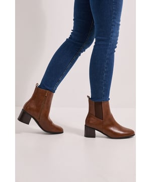 Wide fit design for enhanced comfort and all-day wearability
        Classic Chelsea boot style with elastic side panels for easy slip-on
        Versatile block heel measuring between 5-6.5cm in height
        Sleek, rounded toe shape creates a contemporary silhouette
        Smooth finish with subtle stitching detail for a polished look
    
    These Wide Fit Maias Block Heel Chelsea Boots from Dorothy Perkins offer the perfect blend of style and practicality for your everyday wardrobe. The timeless Chelsea boot design has been thoughtfully crafted with a wider fit to ensure comfort without compromising on style. The mid-height block heel provides just the right amount of elevation whilst remaining comfortable for all-day wear. Style these versatile boots with a checked skirt and tights for a chic daytime look, or pair with straight-leg jeans and an oversized jumper for casual weekend brunches with friends. The classic silhouette makes these boots an excellent choice for family gatherings or casual outings when you want to look put-together without appearing overdressed. Their understated elegance allows for effortless styling across multiple seasons, making them a wardrobe staple you'll reach for time and again.
