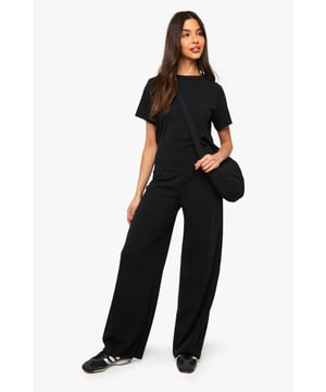 Textured ribbed fabric with slight stretch for all-day comfort
        Elegant tie-back detail creates a flattering silhouette
        Relaxed t-shirt top with contemporary cropped design
        Wide-leg trousers offer effortless movement and style
        Versatile two-piece set that can be worn together or separately
    
    This ribbed co-ord set combines casual comfort with on-trend styling for the perfect everyday ensemble. The relaxed t-shirt features a classic round neckline and short sleeves, while the unexpected tie-back detail adds a touch of feminine flair. The wide-leg trousers create a flowing silhouette that's both comfortable and fashion-forward. Style with trainers as shown for daytime outings, or customise with heels and statement jewellery for evening gatherings. This co-ord works brilliantly for family get-togethers, brunches with friends, or relaxed weekend activities. For cooler days, layer with an oversized denim jacket or chunky cardigan. The beauty of this set lies in its versatility - wear the pieces together for an effortless coordinated look or mix with other wardrobe favourites for countless outfit options.