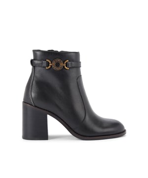This Kurt Geiger Bromley Block Heel Boot is crafted from a black leather. There is an antiqued brass chain detail around the ankle with branding. Heel height: 8cm.