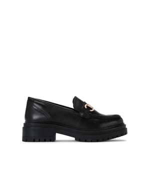 This KG Kurt Geiger Tasha Loafer is crafted from a black leather. There is a gold tone  horse bit chain across the vamp. The sole is extra chunky.