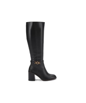 This Bromley Knee High Boot is crafted from a black leather. There is a circular antiqued brass chain trim on the outer side of the ankle. The block heel is in a wooden style. Heel height: 8cm.