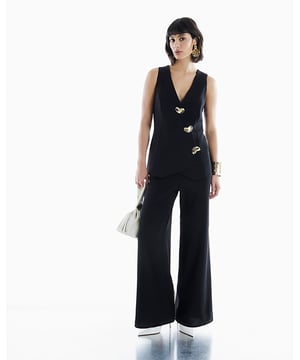 V-neck, Sleeveless, Wide leg, Hybrid design, Asymmetric detail, Gold button embellishment