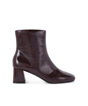 This KG Kurt Geiger Storm Boot is crafted from a wine patent leather alternative. The heel is in a block style and the squared toe is softly rounded. Heel height: 6cm.