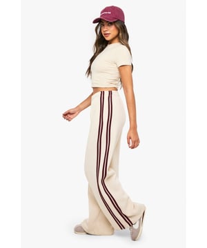 Straight leg joggers featuring distinctive side stripes for a sporty aesthetic
        Pintuck detailing adds texture and dimension to the relaxed silhouette
        Practical side pockets perfect for everyday essentials
        Wide-leg design offers comfort without compromising on style
        Versatile straight fit suitable for casual styling with trainers or fashion-forward looks
    
    These Side Stripe Pintuck Straight Leg Joggers from Boohoo blend athletic inspiration with contemporary fashion sensibility. The straight leg silhouette creates a flattering line whilst the pintuck detailing adds a refined touch to casual attire. Style with a fitted crop top as shown for a balanced silhouette that showcases the high-rise waistband, or pair with an oversized sweatshirt for those laid-back weekend brunches. The contrasting side stripes create visual interest and elongate the legs, making these joggers perfect for casual outings or relaxed gatherings with friends. Complete the look with white trainers and a baseball cap for an effortlessly cool ensemble that transitions seamlessly from daytime errands to casual meet-ups. These joggers represent the perfect fusion of comfort and on-trend styling for the fashion-conscious woman.