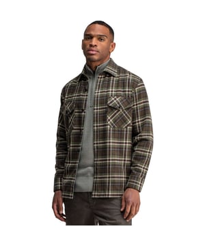 
Het Chief Check overshirt van butcher of blue is een geruit katoenen flanel overhemd in warme groentinten met bruin, ecru en blauw, dat direct sfeer toevoegt aan je dagelijkse look. Het normale, rechte model draagt ontspannen maar heeft toch voldoende structuur; de borstzakken met klep geven een praktische, stijlvolle touch die het zowel solo als open gedragen met een T-shirt eronder werkt.De stof voelt zacht en stevig tegelijk, waardoor het overhemd meebeweegt met je ritme zonder zijn vorm te verliezen, en de geruite print geeft elke outfit karakter zonder opzichtig te zijn. Combineer het met denim of lagen over een fijngebreide trui en voel je direct iets zelfverzekerder en net een stukje stijlvoller.