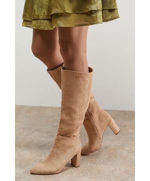 Sleek knee-high boots with a sophisticated pointed toe design
        Comfortable block heel measuring between 7-9cm for all-day wearability
        Soft faux suede finish that adds texture to any outfit
        Side zip fastening for easy wear and secure fit
        Versatile knee-high length that pairs beautifully with dresses and skirts
    
    The Kora Knee Boots from Oasis combine timeless style with modern practicality. The pointed toe silhouette creates a flattering leg-lengthening effect, whilst the sturdy block heel offers stability without sacrificing style. Perfect for daytime outings, these boots look stunning paired with floaty midi dresses as shown, or styled with skinny jeans and an oversized jumper for casual weekend brunches. The knee-high design makes them ideal for autumn through winter, offering extra warmth whilst maintaining a feminine silhouette. For family gatherings, match with a printed dress and textured tights for a look that's both comfortable and put-together. The neutral tone ensures these boots will become a wardrobe staple that complements countless outfits throughout the seasons.