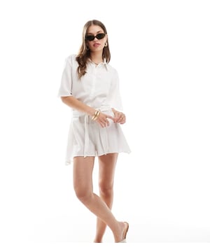 Swimwear & Beachwear by Esmée  Spread collar Button placket Short sleeves Tie waist Regular fitSold By: Asos