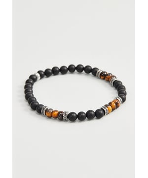Elastisches Armband mit mattschwarzen Onyxsteinen, Tigerauge-Steinen und Edelstahlperle und Stoppern. Edelstahlstopper mit Logo personalisiert.