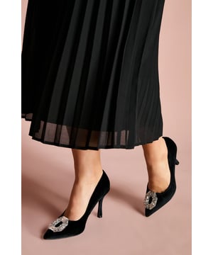 Sumptuous velvet court shoes with an elegant pointed toe silhouette
        Striking crystal brooch detail adds a touch of glamour to the front
        Sophisticated 8cm stiletto heel creates a flattering leg-lengthening effect
        Leather upper ensures comfort and durability for all-day wear
        Versatile design perfect for formal occasions and evening events
    
    The Livvy Velvet Brooch Detail Court Shoes from Coast are the epitome of refined elegance. The luxurious velvet texture creates a rich visual appeal whilst the eye-catching crystal brooch commands attention with every step. Style these sophisticated heels with a pleated midi skirt for a graceful silhouette that's perfect for weddings and formal gatherings. For race day events, pair with a tailored dress and fascinator for a coordinated ensemble that reflects timeless British style. The 8cm stiletto heel offers the perfect balance of height and wearability, whilst the pointed toe elongates the leg for a flattering finish. These courts transition beautifully from daytime ceremonies to evening receptions, making them a versatile addition to your occasion wardrobe that will continue to impress season after season.