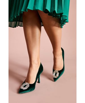 Sumptuous velvet court shoes with an elegant pointed toe silhouette
        Striking crystal brooch detail adds a touch of glamour to the front
        Sophisticated 8cm stiletto heel creates a flattering leg-lengthening effect
        Leather upper ensures comfort and durability for all-day wear
        Versatile design perfect for formal occasions and evening events
    
    The Livvy Velvet Brooch Detail Court Shoes from Coast are the epitome of refined elegance. The luxurious velvet texture creates a rich visual appeal whilst the eye-catching crystal brooch commands attention with every step. Style these sophisticated heels with a pleated midi skirt for a graceful silhouette that's perfect for weddings and formal gatherings. For race day events, pair with a tailored dress and fascinator for a coordinated ensemble that reflects timeless British style. The 8cm stiletto heel offers the perfect balance of height and wearability, whilst the pointed toe elongates the leg for a flattering finish. These courts transition beautifully from daytime ceremonies to evening receptions, making them a versatile addition to your occasion wardrobe that will continue to impress season after season.