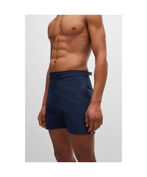 Mens BOSS Lucca Adjustable-waist swim shorts with full lining in navyContemporary swim shorts crafted in recycled material with full lining and an adjustable waist by BOSS. - Adjustable waistband with branded buckle- Front zipper with press button- Side pockets- Back yoke with welt pocket- Main material: 100% Recycled polyamide.  Machine washable.- Ref: 50515739-412