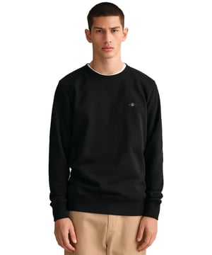 Das Gant Shield Sweatshirt mit Rundhalsausschnitt verfügt über ein klein skaliertes Schildlogo, das auf die Brust gestickt ist. Das Sweatshirt ist mit Rippungen am Kragen, an den Ärmelbündchen und am Saum versehen
