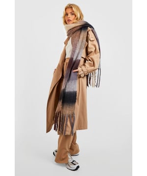 Oversized chunky knit scarf with bold check pattern
        Soft and cosy texture for ultimate comfort
        Stylish tassel fringe detailing adds a playful touch
        Versatile ombre effect for effortless matching
        Generous length allows for various styling options
    
    Wrap yourself in warmth and style with this eye-catching chunky check scarf from Boohoo. Perfect for those chilly days, this oversized accessory is a must-have addition to your winter wardrobe. The bold check pattern and ombre effect create a striking visual appeal, while the soft knit texture ensures maximum comfort. Style it loosely draped over a classic trench coat for a chic daytime look, or bundle up by wrapping it snugly around your neck when the temperature drops. For a casual weekend ensemble, pair it with a cosy jumper, your favourite jeans, and trendy trainers. The versatile nature of this scarf makes it suitable for various occasions, from casual outings to family gatherings. Its generous size allows for creative styling, whether you prefer a traditional loop, an elegant drape, or a fashionable knot. The playful tassel fringe adds a touch of whimsy, making this scarf a standout accessory that will enliven any outfit.