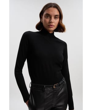 This Karen Millen high neck knit jumper embodies refined casual elegance with its distinctive striped trim detailing. The sophisticated design pairs with tailored trousers, creating a polished daytime ensemble that transitions effortlessly from office to weekend. The contemporary high neck design offers warmth without sacrificing style, making it an essential addition to your autumn and winter wardrobe.  High neck design with contrast stripe detailing Long sleeves Slim fit V-shaped neckline