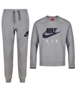 Step out in comfort and classic style with the Nike Air Tracksuit. This 2-piece set includes a crewneck sweatshirt and matching joggers, both crafted from soft fleece fabric for a cosy feel. The sweatshirt features the iconic Nike Air logo boldly across the chest, while the joggers include an elastic drawcord waistband, side pockets, ribbed cuffs, and a matching Nike Air logo on the leg. Perfect for everyday wear, lounging, or casual outings.