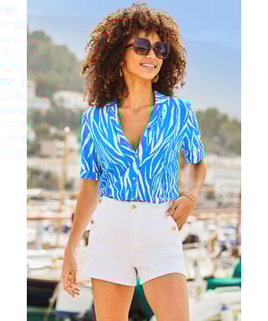 The top that does all the talking Framed by a chic rever collar Cut for a cool relaxed fit Mood-boosting bold blue animal print Turn-up sleeves, because we're all about the little details Jeans, skirts or shorts - it's made for denim