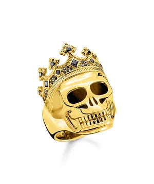 Thomas Sabo Skull Crown Ring. Valuable handmade skull ring with stone-studded crown. High-quality 925 sterling silver with noble 18k gold-plating. A splendid piece of jewellery. This special ring for men makes a statement: it is elaborately handmade and convinces with its high value. The skull ring features a stone-studded royal crown. This makes it sparkle particularly strikingly on the wearer's hand. It is made of high-quality 925 sterling silver and is refined with 18k gold-plating. Make this piece of jewellery your personal companion and wear the royal skull ring like a true queen!. Material: 100% 18K Gold Plated Sterling Silver (Recycled). Ref: TR220741411.