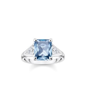 Thomas Sabo Ring with Stones. Cocktail ring made of high-quality 925 Sterling silver in timeless design. Aquamarine-coloured octagon-cut centre stone and small, round-cut zirconia stones in white. Ring for women with high wearing comfort thanks to gently rounded ring body. Timeless elegance: This ring made of high-quality 925 Sterling silver is a stylish cocktail ring. Its aquamarine-coloured centre stone shines in a noble octagon cut and is surrounded by small, round-cut zirconia stones in white. All the stones have been set by hand. The open prong setting intensifies the colourful play of the stones under the light. Thanks to the gently rounded ring shaft, the piece of jewellery is comfortable to wear. It is suitable as a gift for a special occasion and can be excellently combined with other pieces of jewellery in the same design. Material: 100% Sterling Silver (Recycled). Ref: TR23620591.