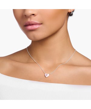 Thomas Sabo Heart Necklace. Filigree necklace made of high-quality 925 Sterling silver with heart pendant. Three-dimensional design with cold enamel, heart-cut zirconia and cut-out on the backside. Chain length adjustable from 40 to 45 cm thanks to extension chain with Charm Club logo. Pop Colours: The delicate necklace made of high-quality 925 Sterling silver is adorned with a pendant in the shape of a heart. It has a three-dimensional design and is hand-painted with cold enamel in a pastel shade of pink ice cream. A pink heart-cut cubic zirconia is the radiant centrepiece. Its back is designed with a heart shaped cut-out through which the stone shines. Thanks to a lobster clasp fastener and an extension chain with Charm Club logo, the necklace with pendant can be adjusted from 40 to 45 cm. Other pieces of jewellery in the same design, such as the bracelet, ear studs and ring, are ideal combination partners. Material: 100% Sterling Silver (Recycled). Ref: KE21840419.