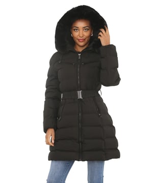 This winter, stay warm and fashionable with our Ladies Hooded Long Coat, which is made to be both comfortable and elegant. With the detachable buttoned faux fur trim on the hood of this padded puffer-style jacket, you can wear it in two different ways. This coat offers complete protection from the cold thanks to its zip fastening and secure button. There is ample room for storing your necessities thanks to the two side zip pockets, two chest-high zip pockets, and an extra arm zip pocket. The long length guarantees additional warmth on chilly days, and the belted waist adds a flattering fit. This coat blends style and utility, making it ideal for evening events, outdoor pursuits, and daily wear. An essential winter coat for ladies who appreciate both fashion and functionality.