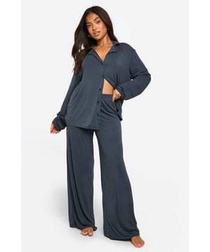 Soft jersey fabric for ultimate comfort
        Long-sleeved button-up top with relaxed fit
        Wide-leg trousers for unrestricted movement
        Versatile two-piece set for mix-and-match styling
        Petite sizing ensures perfect fit for shorter frames
    
    Indulge in luxurious comfort with this chic petite pyjama set from Boohoo. The long-sleeved top features a relaxed silhouette and button-up front, perfect for those who prefer a bit of coverage during cooler nights. Paired with wide-leg trousers, this set offers unrestricted movement for a restful night's sleep. The soft jersey fabric drapes beautifully, creating a flattering look that's both comfortable and stylish. Whether you're having a lazy Sunday morning or hosting a sleepover with friends, this versatile set can be mixed and matched with other loungewear pieces for endless styling options. The petite sizing ensures a perfect fit for shorter frames, eliminating the need for alterations. Embrace the ultimate blend of comfort and style with this must-have addition to your nightwear collection.
