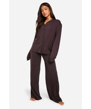 Soft jersey fabric for ultimate comfort
        Button-down shirt with relaxed fit
        Long sleeves with cuffed ends
        Wide-leg trousers for unrestricted movement
        Versatile two-piece set for mix-and-match options
    
    Indulge in luxurious comfort with this petite long-sleeved pyjama set from Boohoo. Perfect for those cosy nights in, this ensemble combines style and relaxation effortlessly. The button-down shirt offers a classic look while providing easy wear, and the wide-leg trousers ensure unrestricted movement for a restful sleep. Crafted from soft jersey fabric, this set is ideal for lounging around the house or settling in for a night of sweet dreams. For a touch of glamour, pair the top with your favourite leggings for a quick dash to the corner shop, or team the bottoms with a cropped tee for a lazy Sunday morning. Whether you're having a solo pamper session or hosting a sleepover with your besties, this versatile pyjama set is your go-to for both style and comfort.
