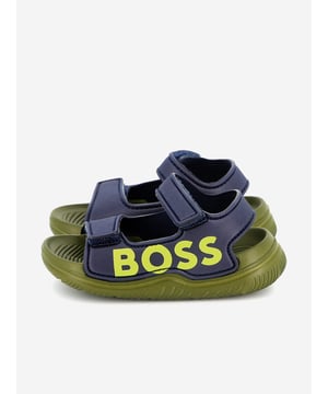 Introducing the sophisticated BOSS Boys Logo Sandals in Navy, an essential addition to any young gentleman's SS2025 wardrobe. Here are the features that set these stylish sandals apart:

Elegant Navy Hue: A classic, deep blue colour that complements any outfit.
Signature Logo Detailing: Prominently features the iconic BOSS logo for an upscale touch.
Premium Comfort: Crafted with luxurious materials to provide unmatched comfort and durability.
Versatile Style: Perfect for both casual outings and formal occasions.

Elevate your boy's style with these chic BOSS sandals—available now!
