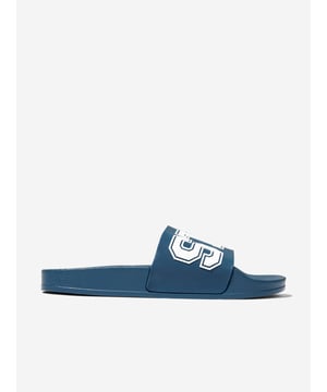 Step into style with the Stella McCartney Boys Logo Sliders in Blue—a quintessential addition for the fashionable young lad's SS2025 wardrobe. Masterfully crafted, they blend iconic aesthetics with unparalleled comfort, making them an undeniable choice for both relaxed days and vibrant outings. Key features include:

**Iconic Blue Hue:** A deep, rich blue that captures Stella McCartney's signature sophistication.

**Distinctive Logo Embellishment:** Prominent branding ensures these sliders stand out in any crowd.

**Supreme Comfort:** Engineered for all-day wearability without compromising on style.

Elevate your young gentleman's ensemble with these stellar sliders—where fashion meets function.