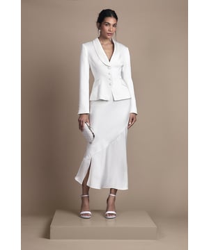 Elegant fitted skirt with luxurious satin detailing for a sophisticated bridal aesthetic
        Flattering midi length with a contemporary side split for graceful movement
        Sleek silhouette that contours to your figure with a subtle flare towards the hem
        Versatile design that pairs beautifully with the matching tailored jacket for a complete bridal ensemble
        Thoughtful construction with a comfortable stretch element for ease of wear throughout your special day
    
    This exquisitely crafted fitted skirt from Coast embodies timeless bridal elegance with modern sensibility. The refined satin detailing adds a subtle lustre to the structured silhouette, while the contemporary side split ensures you can move with grace and poise throughout your wedding celebrations. Style with the coordinating tailored jacket for a sophisticated bridal look that reflects classic tailoring with a contemporary twist. For a complete ensemble, pair with delicate strappy heels and a clutch bag as shown. The midi length offers a refined alternative to traditional bridal wear, making it perfect for registry ceremonies, intimate weddings, or as a stunning outfit change for evening receptions. This versatile piece transitions beautifully from the ceremony to celebration, ensuring you feel confident and elegant on your most treasured day.