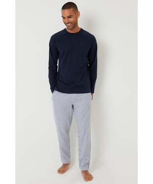 Get a good night’s sleep in this long pyjama set from Threadbare. This 2-piece set features a cotton blend long sleeve top with chest embroidery and a ribbed crew neck, paired with brushed cotton stripe bottoms that have an elasticated waistband, drawcords and side entry pockets. Ideal for relaxing or lounging around the house.