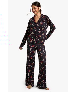 Festive candy cane and bow print throughout
        Long-sleeved button-up top with notched collar
        Matching wide-leg trousers for ultimate comfort
        Relaxed fit for unrestricted movement
        Perfect for cosy nights in and festive lounging
    
    Embrace the holiday spirit with this charming Christmas-themed pyjama set from Boohoo. The playful candy cane and bow print adds a touch of whimsy to your nightwear collection, making bedtime a joyful experience. The long-sleeved top features a classic notched collar and button-up front, offering a smart yet comfortable look. Paired with wide-leg trousers, this set ensures unrestricted movement for a restful night's sleep. Whether you're curling up with a good book, enjoying a festive film marathon, or simply lounging about on Christmas morning, this pyjama set is the perfect choice. Its versatile design makes it ideal for year-round wear, allowing you to carry the holiday cheer well beyond the festive season. For a complete look, pair with fluffy slippers and a warm dressing gown for the ultimate in cosy comfort.