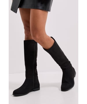 Sleek knee-high design with a flat heel measuring between 0-2cm for all-day comfort
        Smooth PU finish that maintains its appearance throughout the seasons
        Full-length inner zip for easy wear and removal
        Rounded toe shape offering ample room for comfort
        Subtle stitching detail that adds refined texture to the minimalist design
    
    The Karla Flat Knee High Boots from Dorothy Perkins present the perfect balance of style and practicality for the modern woman. These versatile boots pair beautifully with both casual and smart-casual ensembles - try them with a leather-look mini skirt as shown, or style with slim-fit jeans tucked in for effortless weekend chic. The flat sole ensures comfort for busy days, whether you're dashing between meetings or enjoying a leisurely brunch with friends. Their understated design makes them ideal for family gatherings or baby showers where you want to look polished without appearing overdressed. The knee-high silhouette adds a touch of sophistication to autumn and winter outfits, while the classic shape ensures they'll remain a wardrobe staple for seasons to come. These boots truly shine when paired with textured tights and a flowing midi dress for those cooler transitional months.