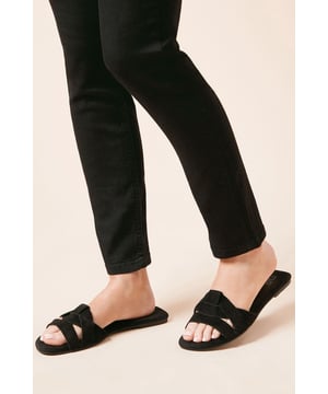 Suede twisted strap design for a chic look
        Flat heel between 0 and 2cm for all-day comfort
        Open-toe mule style for easy slip-on wear
        Versatile slider perfect for casual daywear
        Soft synthetic lining for a comfortable fit
    
    Step into effortless style with the Freesia Suede Twisted Flat Mule Slider from Dorothy Perkins. These sandals showcase a unique twisted strap design that adds a touch of sophistication to your casual ensemble. The flat heel ensures comfort for those busy days, whether you're running errands or meeting friends for a leisurely brunch. Pair these versatile sliders with cropped trousers and a flowing blouse for a relaxed yet put-together look. They're ideal for family gatherings or casual outings where you want to combine style and comfort. The open-toe design is perfect for showcasing your favourite pedicure, while the slip-on style allows for quick and easy wear. These mule sliders are a must-have addition to your summer wardrobe, offering both fashion and functionality for the modern woman who values comfort without compromising on style.