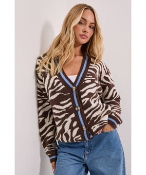 Bold animal print pattern for a statement casual look
        V-neckline with contrasting trim detail for added interest
        Button-through front design for versatile styling options
        Relaxed fit with ribbed cuffs and hem for comfort
        Soft knitted fabric perfect for layering throughout the seasons
    
    Make a stylish statement with this eye-catching animal print cardigan from Dorothy Perkins. The striking pattern is complemented by contrasting trim details along the V-neckline and button placket, adding a contemporary twist to a classic silhouette. Style it as seen with a simple vest top and wide-leg jeans for a relaxed weekend brunch with friends, or layer over a fitted dress for baby showers and family gatherings. The versatile button-through design allows you to wear it open as a light layer or fully fastened as a statement jumper. This cardigan transitions effortlessly between seasons - pair with trainers and a crossbody bag for casual daytime outings or dress up with ballet flats and tailored trousers for a more polished look that doesn't compromise on comfort.