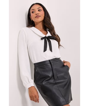 Elegant V-neckline with contrasting collar detail for a sophisticated touch         Charming bow front design adds feminine flair to this versatile blouse         Long sleeves with gentle gathering at the cuffs for a refined silhouette         Lightweight woven fabric offers comfortable wear throughout the day         Regular fit design ensures easy movement while maintaining a polished appearance
    
    This delightful Collar Detail Bow Front Blouse from Dorothy Perkins strikes the perfect balance between classic and contemporary style. The distinctive collar and bow detail create visual interest whilst maintaining a refined aesthetic that works beautifully for various occasions. Style with a leather-look skirt and loafers for a chic daytime look that transitions effortlessly from office to casual outings. For weekend brunches with friends, pair with your favourite denim and ballet flats for an understated yet put-together ensemble. The versatile design makes it an excellent choice for family gatherings or baby showers when styled with tailored trousers and subtle jewellery. This blouse offers the perfect foundation for creating numerous outfits that reflect your personal style whilst ensuring you look appropriately dressed for any casual event.