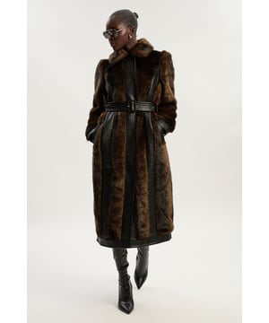 Make a sophisticated statement in this sumptuous faux fur midi coat from Karen Millen. The contrasting PU panels create a sleek silhouette while the detachable belt allows you to customise your look. The petite fit ensures the proportions are perfectly balanced for smaller frames, eliminating the need for alterations. A true investment piece that combines expert craftsmanship with contemporary glamour.  Faux fur midi coat with striking PU panelled detailing Detachable belt with rectangular buckle Round neckline Designed specifically for petite frames Practical side pockets