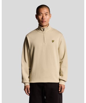Dieses atmungsaktive Sweatshirt mit 1/4-Reißverschluss besteht aus weichem Baumwoll-Schlingengewebe, das zuverlässigen Komfort und einfaches Übereinandertragen bietet. Sein klares Design und die gerippten Abschlüsse machen es zu einem vielseitigen Teil für lässige und alltägliche Outfits.  
- Weiches Baumwoll-Schlingengewebe für leichte Wärme - Klassischer 1/4-Reißverschluss mit Stehkragen - Gerippte Bündchen und Saum für einen ordentlichen Abschluss - Ideal zum Übereinandertragen oder als eigenständiger Stil