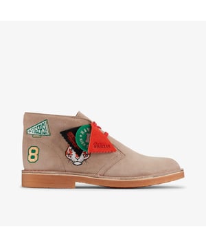 Our iconic Desert Boot takes on Stranger Things in a unique design inspired by the nostalgic team spirit of Hawkins High School. Its sand suede uppers are complete with embroidered badges that pay tribute to The Hawkins Tigers, as well as as a fierce Demogorgon motif in bold red to match the laces. Calling attention to Originals heritage and Stranger Things lore, we've topped the pair with suede logo fobs that immortalise the collaboration.